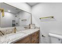 Bathroom with white marble counter, gold faucet and hardware and a decorative sign at 3011 E John Cabot Dr, Phoenix, AZ 85032