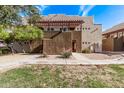 Condominium exterior featuring a private entrance, stucco facade, and landscaped front yard at 3434 E Baseline Rd # 214, Phoenix, AZ 85042