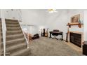 Bright living space with a cozy fireplace and a staircase leading to the loft at 3491 N Arizona Ave # 118, Chandler, AZ 85225