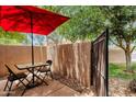 Private outdoor patio with table, chairs, and red umbrella at 3491 N Arizona Ave # 118, Chandler, AZ 85225