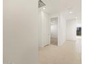 Bright hallway with tile flooring, recessed lighting, and white doors leading to various rooms at 4256 W Lisa Ln, San Tan Valley, AZ 85144