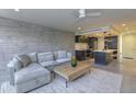 Open concept living room and kitchen area with modern finishes and a large comfortable sofa at 4411 N 40Th N St # 37, Phoenix, AZ 85018