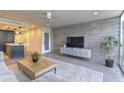 Modern living room featuring sleek furniture, exposed brick wall, and an open layout at 4411 N 40Th N St # 37, Phoenix, AZ 85018
