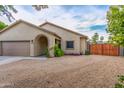 Charming single-story home featuring desert landscaping, neutral color palette, and a two-car garage at 4446 W Kimberly Way, Glendale, AZ 85308