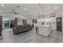 Spacious open-concept living area with kitchen, dining area, comfortable seating, and stylish lighting at 4446 W Kimberly Way, Glendale, AZ 85308