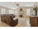 Cozy living room with vaulted ceiling, fireplace, and ample natural light from shuttered windows at 4515 E Casey Ln, Cave Creek, AZ 85331