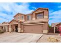 Two-story home boasts a two-car garage, a cozy front porch and low-maintenance landscaping at 45574 W Tulip Ln, Maricopa, AZ 85139