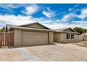 Home showcasing a two-car garage, brickwork facade, and landscaped front yard at 5101 E Toniko Dr, Phoenix, AZ 85044