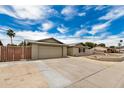 Home showcasing a two-car garage, brickwork facade, and landscaped front yard at 5101 E Toniko Dr, Phoenix, AZ 85044