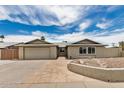 Charming single-story home featuring a stone walkway and a spacious two-car garage at 5101 E Toniko Dr, Phoenix, AZ 85044