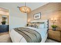 Comfortable main bedroom featuring a statement headboard, stylish lighting, and textured accent wall at 8149 E Petunia Ave # 1054, Mesa, AZ 85212