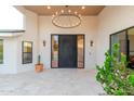 Inviting front entrance featuring a statement chandelier and modern design elements at 8230 E Wood Dr, Scottsdale, AZ 85260