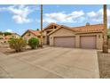 Charming single-story home featuring a neutral color palette, tile roof, and a spacious two-car garage at 8913 S Forest Ave, Tempe, AZ 85284