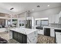 Bright kitchen featuring marble countertops, stainless steel appliances and an adjacent breakfast nook at 8913 S Forest Ave, Tempe, AZ 85284