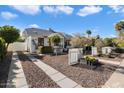 View of the house with driveway, gravel landscaping, a walkway to the front door, and clear blue skies at 905 E Coronado Rd, Phoenix, AZ 85006