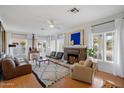 Bright living room with hardwood floors, a decorative fireplace, large windows, and stylish furnishings at 905 E Coronado Rd, Phoenix, AZ 85006