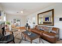 Comfortable living room featuring a large mirror, fireplace, hardwood floors, and stylish leather sofa at 905 E Coronado Rd, Phoenix, AZ 85006