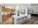 Bright kitchen featuring a breakfast bar, stainless steel appliances, and light wood cabinetry at 1029 E Ian Dr, Phoenix, AZ 85042
