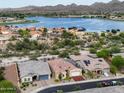 Gorgeous aerial view of the home overlooking the lake and mountain landscape at 10507 S 181St Ave, Goodyear, AZ 85338
