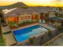 Inviting backyard oasis with a sparkling pool, covered patio, and mountain views at 10507 S 181St Ave, Goodyear, AZ 85338