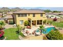 Aerial view of the private backyard with pool, spa, patio, fire pit, and mountain views at 11150 S Star Ct, Goodyear, AZ 85338