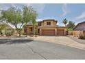 Beautiful two-story home featuring a three-car garage, desert landscaping, and a well-maintained front yard at 11150 S Star Ct, Goodyear, AZ 85338