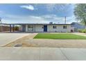 Charming home with a blue door, modern windows, and low-maintenance landscaping at 1209 E Marigold Ln, Tempe, AZ 85288