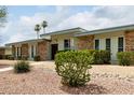 Well-maintained single-story home featuring decorative gravel, desert plants, and stone exterior accents at 13428 N 100Th Ave, Sun City, AZ 85351