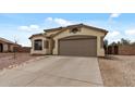 Charming single-story home with a two-car garage and low-maintenance desert landscaping in the front yard at 13438 N 130Th Ln, El Mirage, AZ 85335