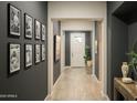 Inviting hallway with neutral-toned walls and flooring, enhanced by decorative artwork and natural light at 1529 W State Ave, Phoenix, AZ 85021