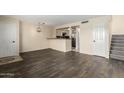 An open-concept room features wood floors, fresh paint, and an interesting light fixture at 1645 W Baseline Rd # 2098, Mesa, AZ 85202
