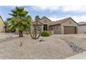 Beautiful home with desert landscaping including palm trees and cacti at 16514 W Sandia Park Dr, Surprise, AZ 85374