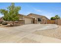 Charming single-story home featuring stone accents, a well-manicured lawn, and a welcoming facade at 17292 W Pinnacle Vista Dr, Surprise, AZ 85387