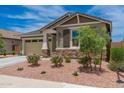 Attractive single-Gathering home with a well-manicured front yard and desert landscaping at 19968 W Flower St, Buckeye, AZ 85396