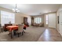 Inviting living room with neutral walls, plush carpeting, natural light, and elegant dining and seating furniture at 2102 S Sabrina --, Mesa, AZ 85209