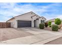 A well-kept single-story home with a two-car garage, complemented by desert landscaping and a concrete driveway at 2614 S 120Th Ave, Avondale, AZ 85323