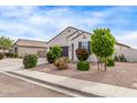 Attractive single-story house with desert-style landscaping, a two-car garage, and a well-manicured lawn at 2614 S 120Th Ave, Avondale, AZ 85323