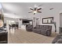 Open-concept living room flows to kitchen, tile floors, fan, neutral gray walls at 2614 S 120Th Ave, Avondale, AZ 85323