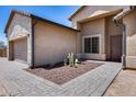 Close up of the home's entrance with a desert landscaped yard and paver walkway at 30511 N 162Nd Way, Scottsdale, AZ 85262