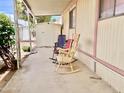 Inviting covered porch with rocking chairs for relaxing outdoors at 318 S Crismon Rd # 65, Mesa, AZ 85208