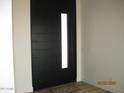 Modern front door with a vertical window pane and sleek design at 34449 N Elk Run Rd, San Tan Valley, AZ 85143