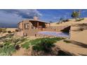 Beautiful backyard featuring a stylish pool and deck, perfectly integrated into the desert landscape at 3545 N Vista Way # 404, Buckeye, AZ 85396