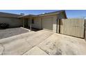 Single-story home with gravel front yard and a mix of concrete and gravel driveway leading to a garage at 3814 N 55Th Dr, Phoenix, AZ 85031