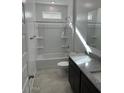 Bathroom featuring a shower-tub combo, granite vanity, and ample lighting at 38150 W Bello Ln, Maricopa, AZ 85138