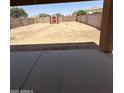 Large, empty backyard with block wall fencing and a storage shed at 40246 W Hopper Dr, Maricopa, AZ 85138