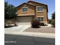 Two-story home with desert landscaping, attached two-car garage, and a neutral color palette at 40246 W Hopper Dr, Maricopa, AZ 85138