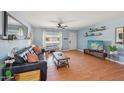 Bright living room with hardwood floors, ceiling fan, and plenty of natural light at 5133 E Keresan St, Phoenix, AZ 85044