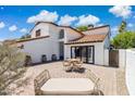 An expansive patio with a daybed and dining table, perfect for outdoor entertaining and relaxation at 5556 E Sandra Ter, Scottsdale, AZ 85254