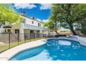 Beautiful backyard with a sparkling pool, secure fencing, and lush greenery at 5556 E Sandra Ter, Scottsdale, AZ 85254
