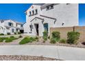 Inviting two-story home with a landscaped front yard and a private side yard at 651 N Bay Dr, Gilbert, AZ 85233